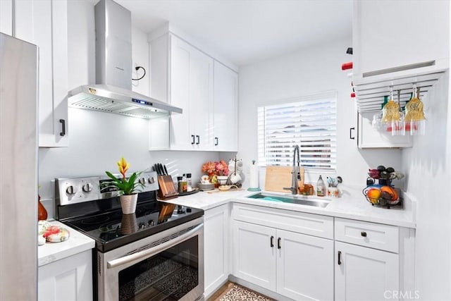 kitchen with white cabinets, stainless steel electric stove, sink, and exhaust hood