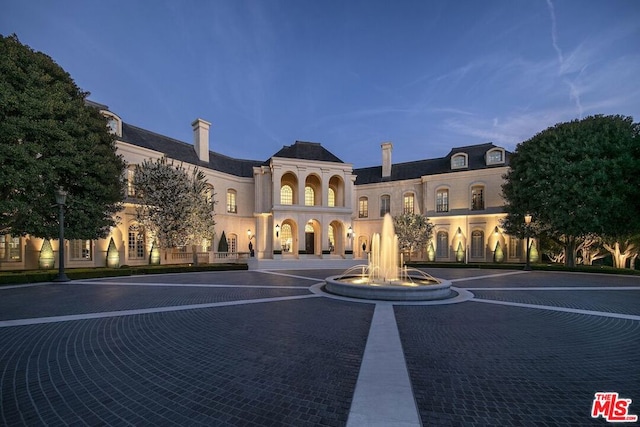 view of outdoor building at dusk