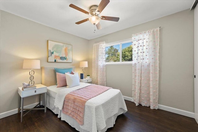 bedroom with dark hardwood / wood-style floors and ceiling fan