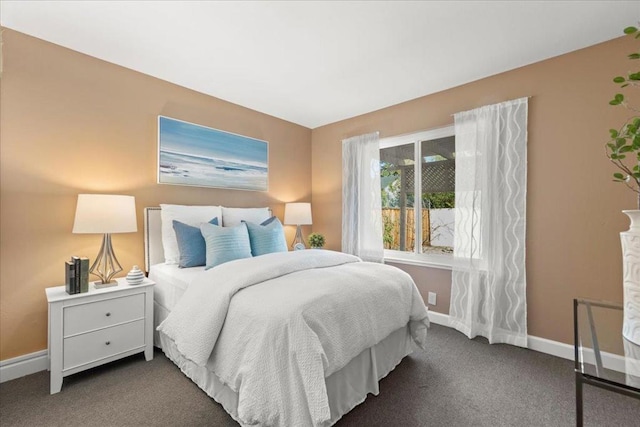 bedroom with dark colored carpet