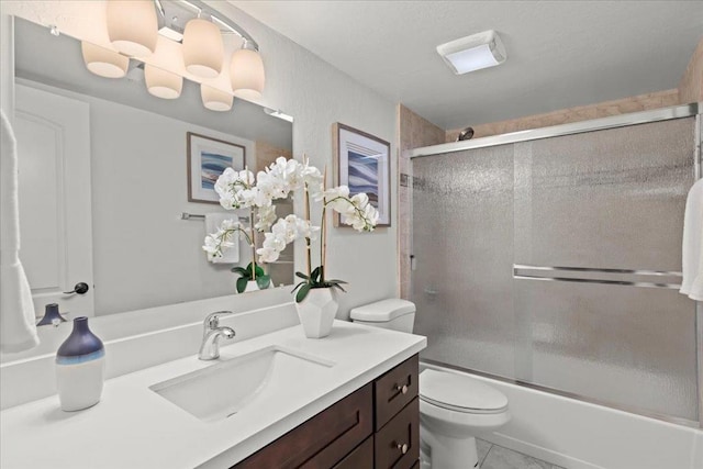 full bathroom with toilet, bath / shower combo with glass door, vanity, and tile flooring