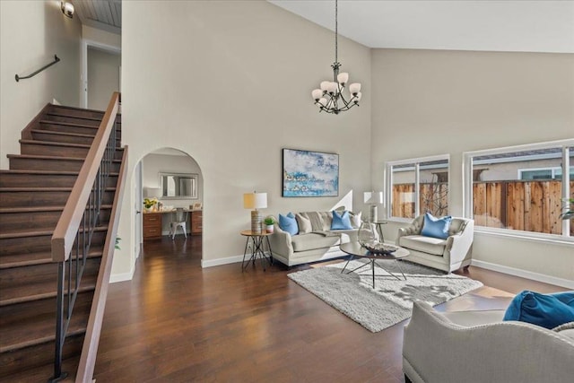 living room featuring high vaulted ceiling, dark hardwood / wood-style flooring, and a chandelier