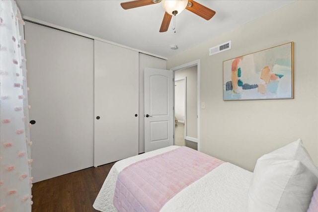 bedroom featuring a closet, dark hardwood / wood-style floors, and ceiling fan