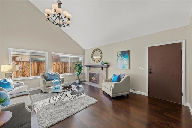 living room featuring high vaulted ceiling, dark wood-type flooring, and a chandelier