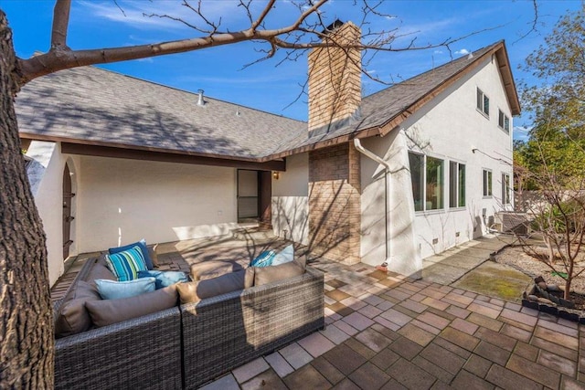 back of property featuring an outdoor living space and a patio