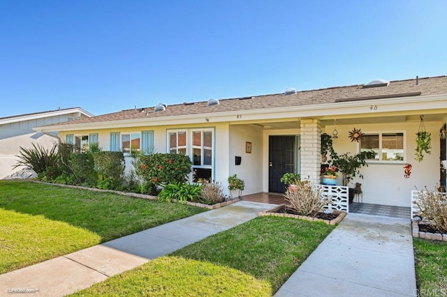 ranch-style home with a front yard and covered porch