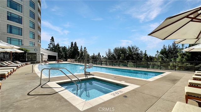 view of pool with a community hot tub and a patio area