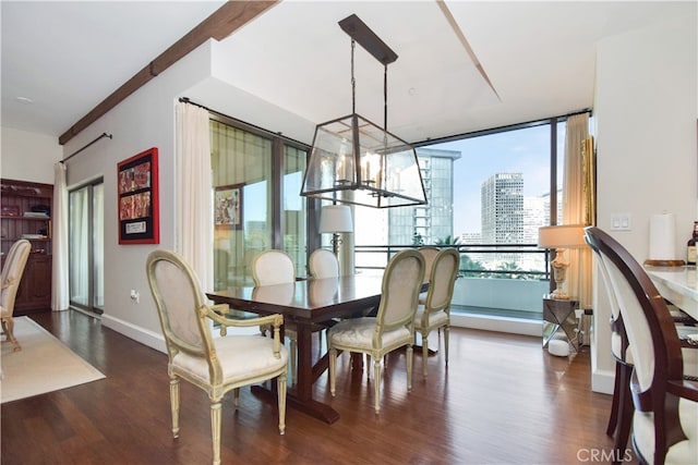 dining room featuring plenty of natural light, a notable chandelier, and dark wood-type flooring