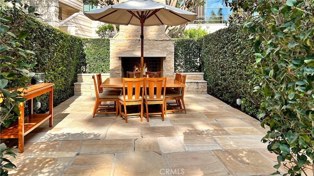 view of patio featuring an outdoor stone fireplace