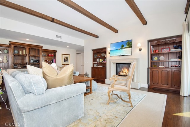 living room with beam ceiling and dark hardwood / wood-style flooring