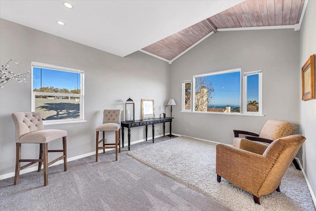 living area with carpet, wood ceiling, and crown molding