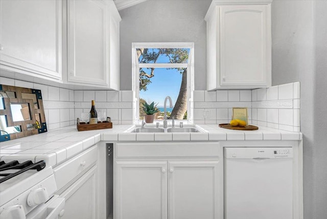 kitchen with tasteful backsplash, tile countertops, dishwasher, and white cabinetry