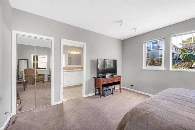 bedroom with light tile patterned flooring and ensuite bathroom