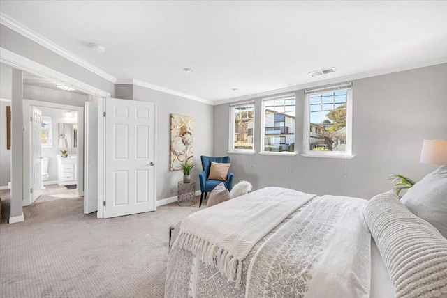 bedroom featuring connected bathroom, light colored carpet, and crown molding