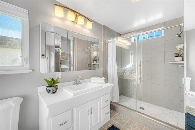 bathroom with a wealth of natural light, toilet, vanity, and an enclosed shower