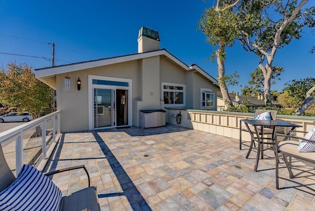 back of property with a patio