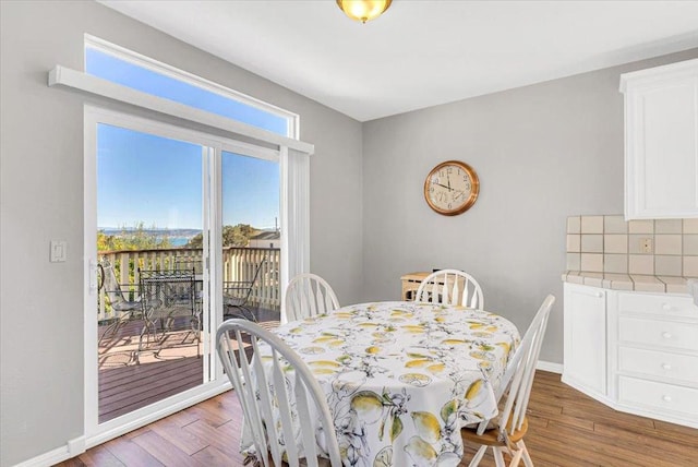 dining space with hardwood / wood-style floors