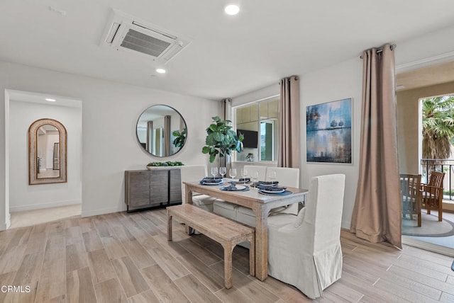 dining space with light hardwood / wood-style flooring