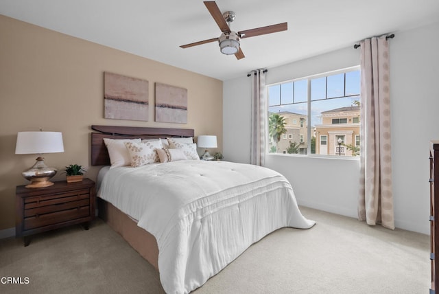 bedroom featuring light carpet and ceiling fan