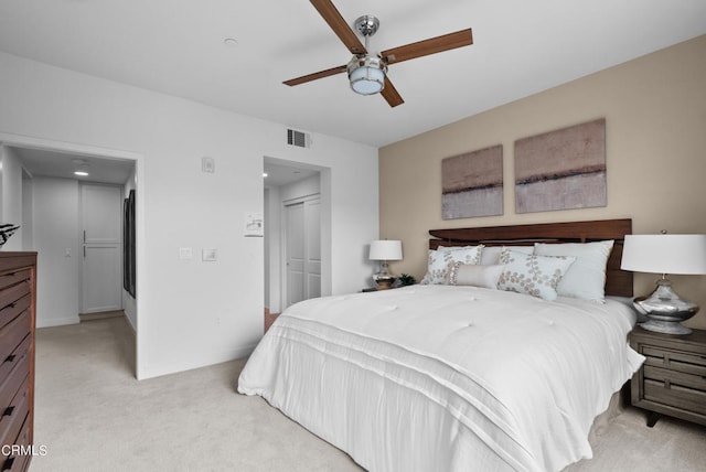 bedroom featuring light carpet, a closet, and ceiling fan