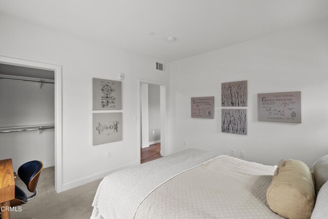 bedroom featuring a closet and light colored carpet