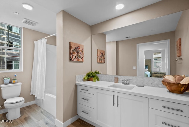 full bathroom with shower / bath combo with shower curtain, toilet, and oversized vanity