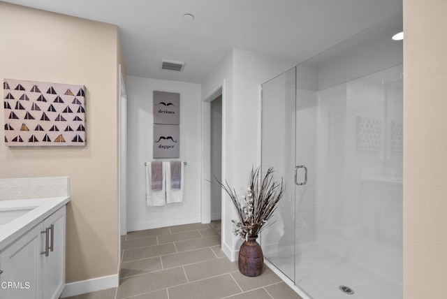 bathroom with walk in shower, tile floors, and vanity