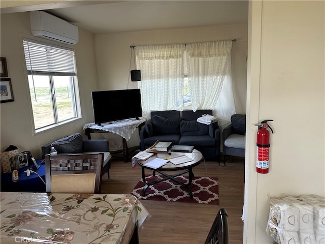 living room featuring a wall mounted AC and dark hardwood / wood-style floors