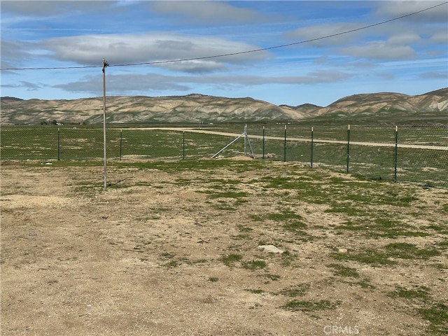 view of yard with a rural view and a mountain view