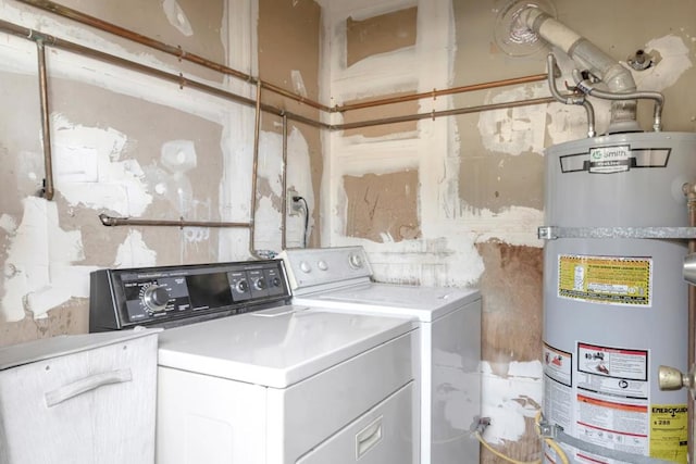 clothes washing area with washing machine and clothes dryer and secured water heater