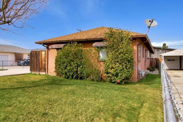 view of property exterior featuring a lawn and a garage