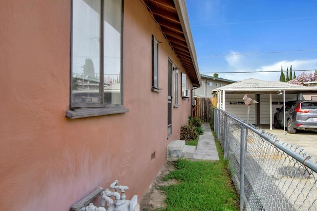 view of side of property with a carport