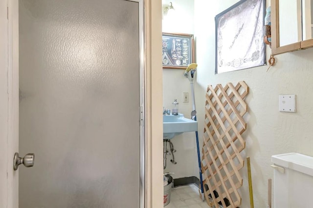 bathroom featuring toilet and tile flooring