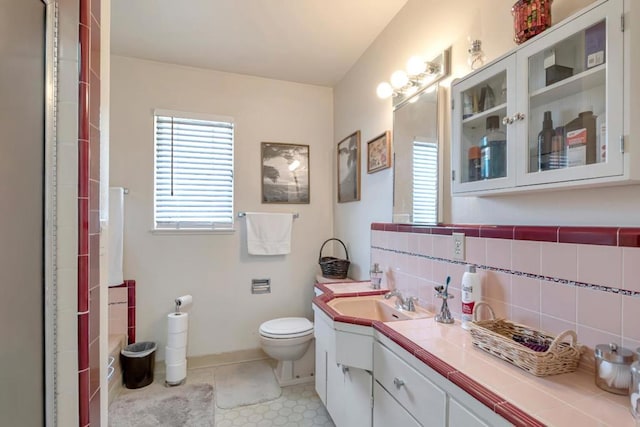 bathroom with backsplash, oversized vanity, toilet, and tile floors