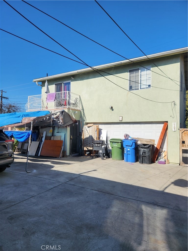 exterior space with a balcony and a garage