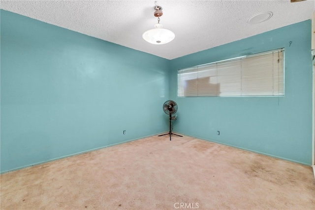 empty room featuring a textured ceiling and carpet floors