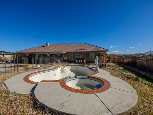 view of swimming pool featuring an in ground hot tub