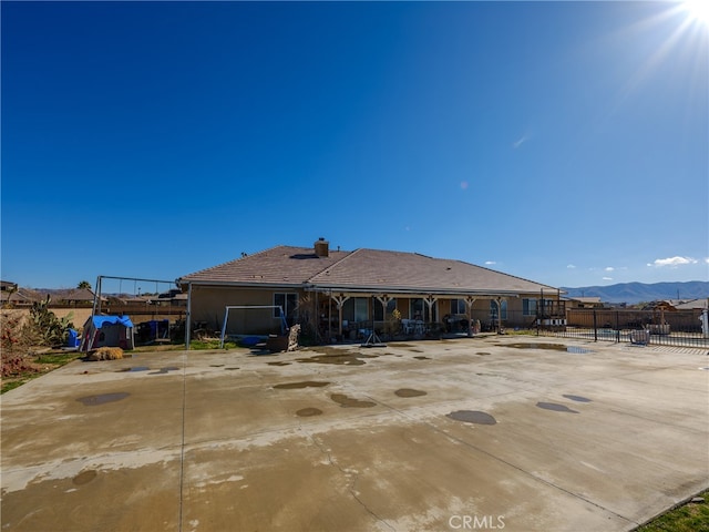 back of house featuring a patio area and a mountain view