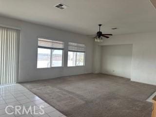 unfurnished room featuring carpet and ceiling fan