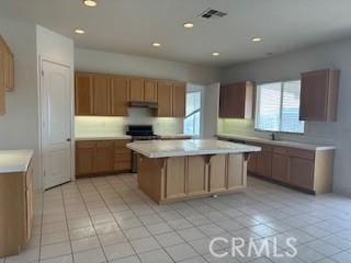 kitchen with a center island and light tile patterned floors