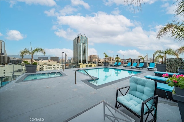 view of pool with a community hot tub and a patio area