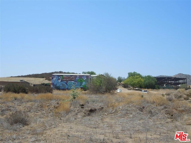 view of yard with a rural view