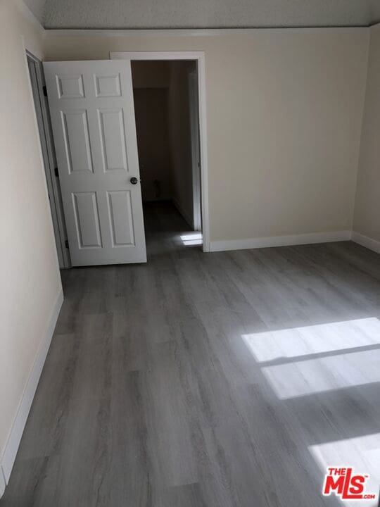 spare room with dark hardwood / wood-style flooring