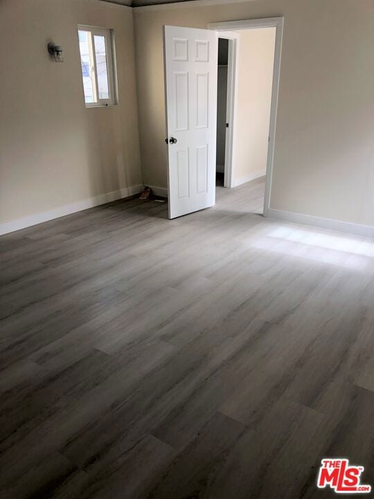 unfurnished room with hardwood / wood-style flooring