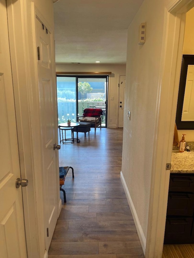 hallway featuring dark wood-type flooring