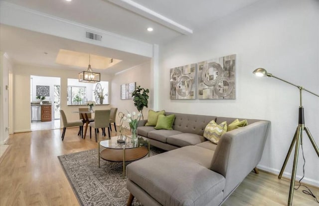 living room featuring a notable chandelier and hardwood / wood-style floors