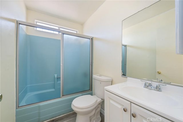 bathroom featuring vanity, shower / bath combination with glass door, and toilet