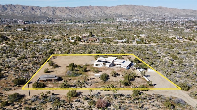 birds eye view of property with a mountain view