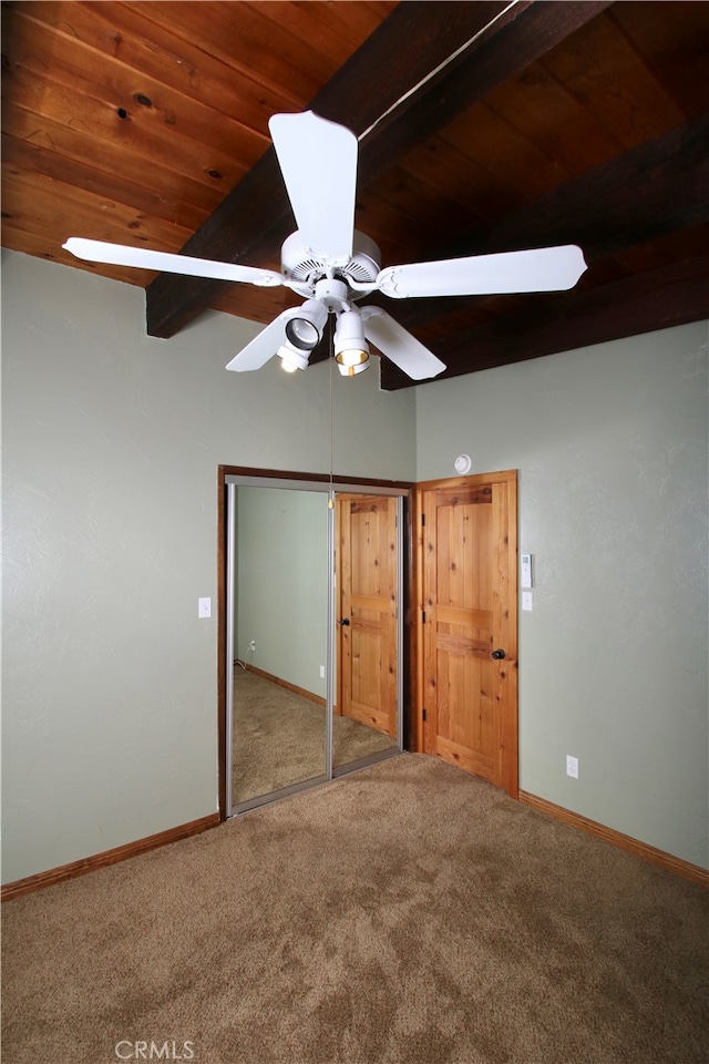 unfurnished bedroom featuring carpet floors, a closet, ceiling fan, and wood ceiling