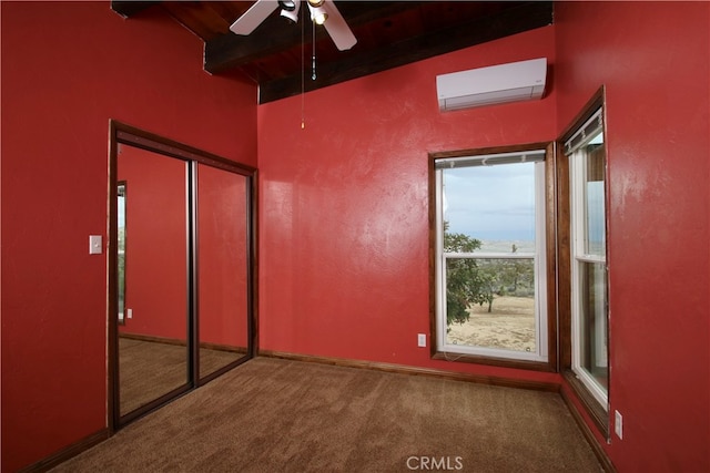 interior space featuring beam ceiling, ceiling fan, and a wall mounted air conditioner